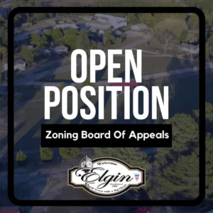 A sign reads Open Position Zoning Board Of Appeals with the Elgin city logo at the bottom.
