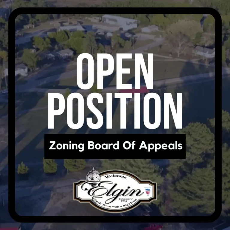 A sign reads Open Position Zoning Board Of Appeals with the Elgin city logo at the bottom.
