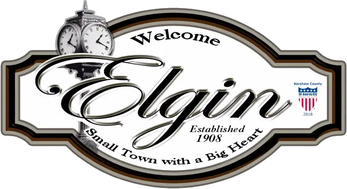 Welcome sign for Elgin, established 1908, with a clock and Small Town with a Big Heart slogan.